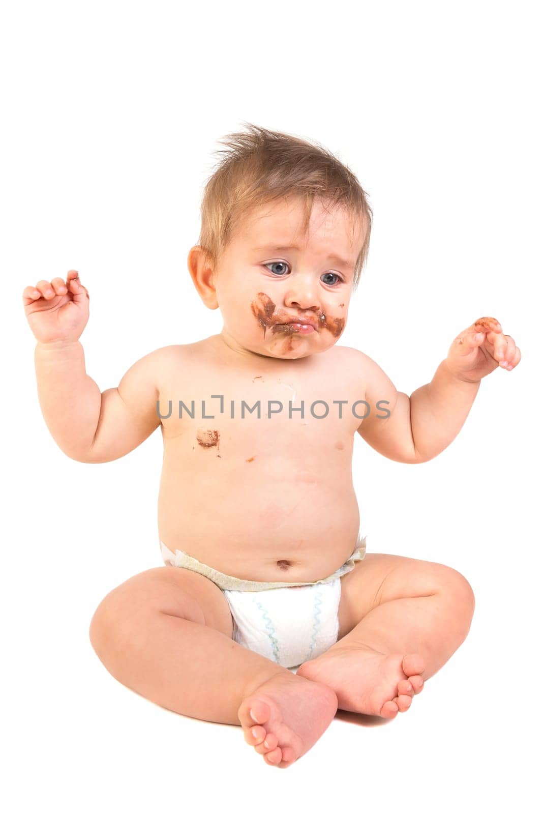 Beautiful baby boy covered in chocolate isolated in white background