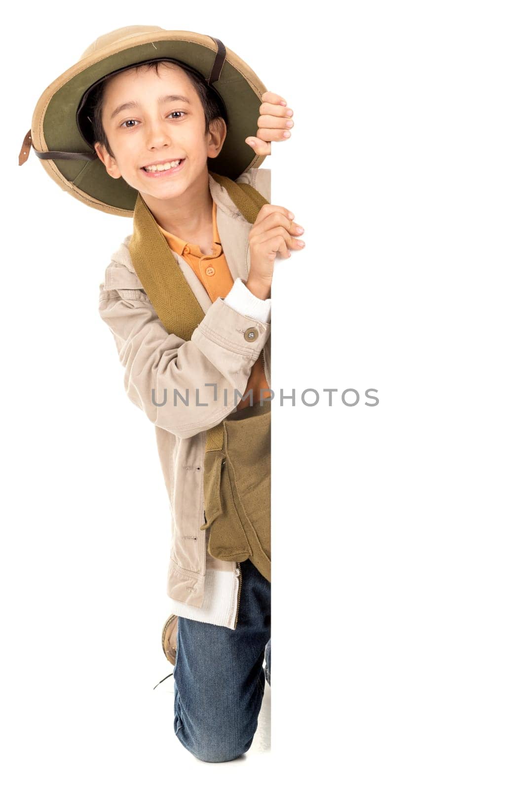 Young boy with Safari clothes behind a white board isolated in white