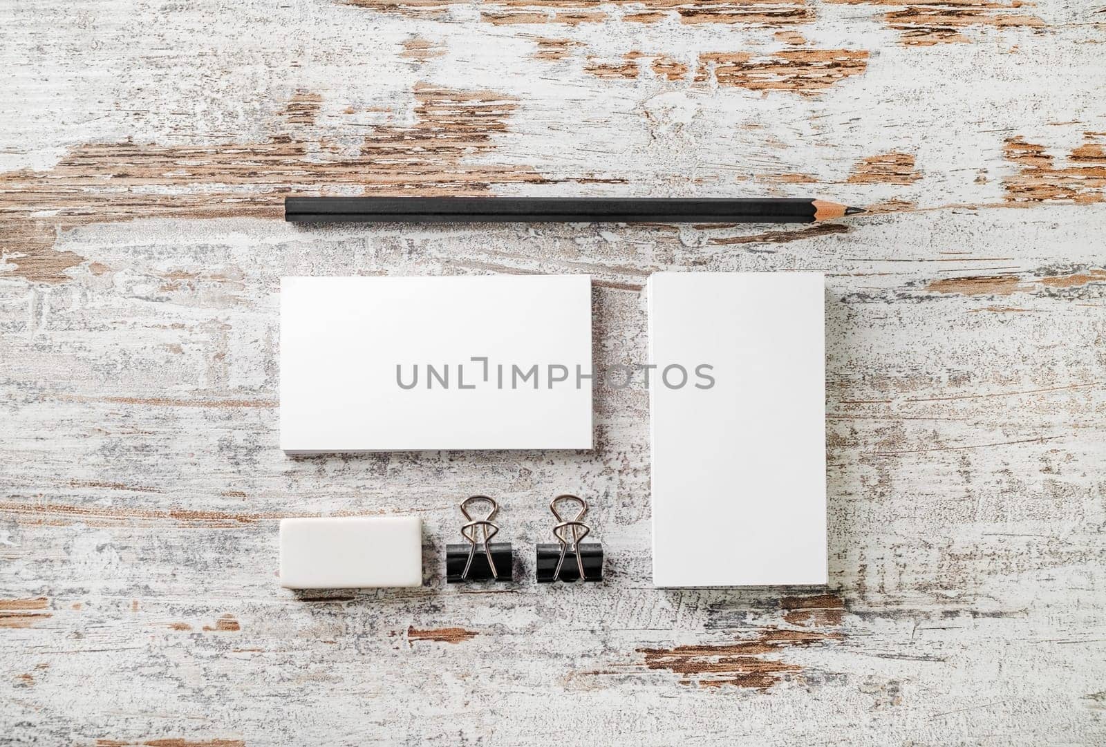 Blank stationery template for placing your design. Photo of blank branding mockup. Bank business cards, pencil, eraser, badge and sharpener. Top view.
