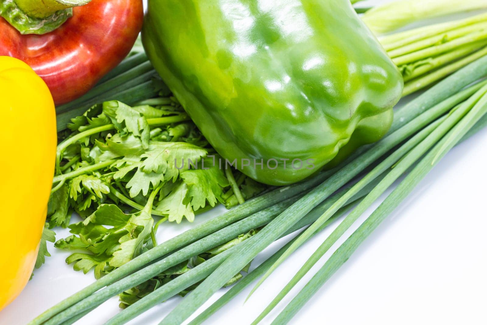 colored peppers over white background with Fresh vegetables