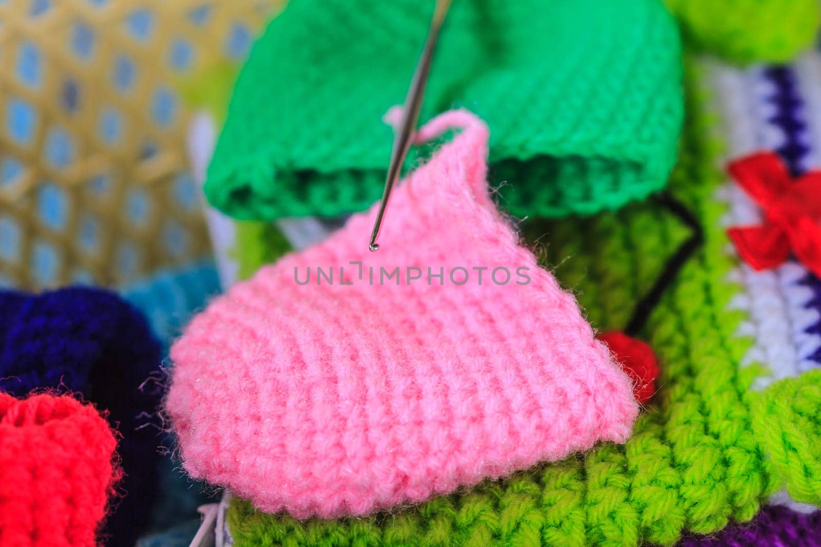 Crochet hook needle on granny square blanket, handmade art and crafts