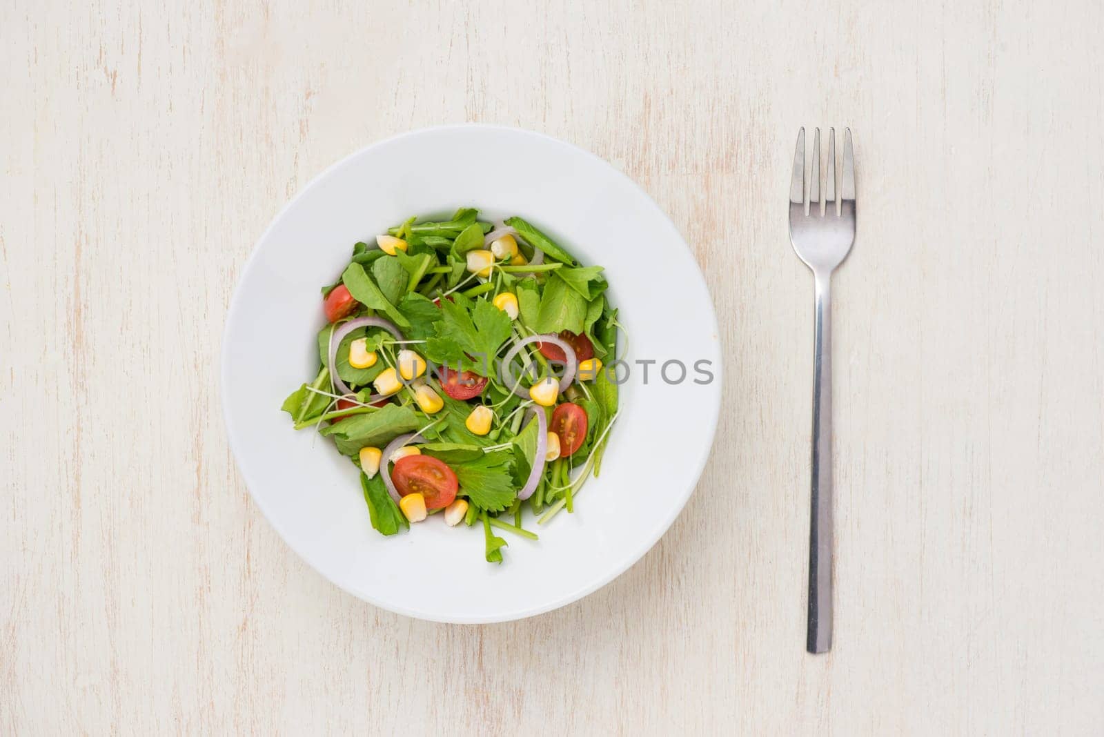 Homemade fresh green vegetable salad on table.