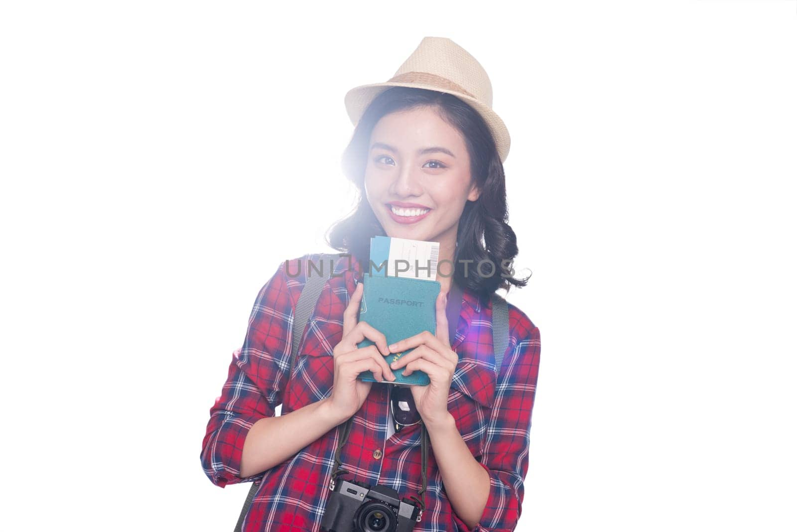 Woman travel. Young beautiful asian woman traveler holding passport and air ticket standing over white.