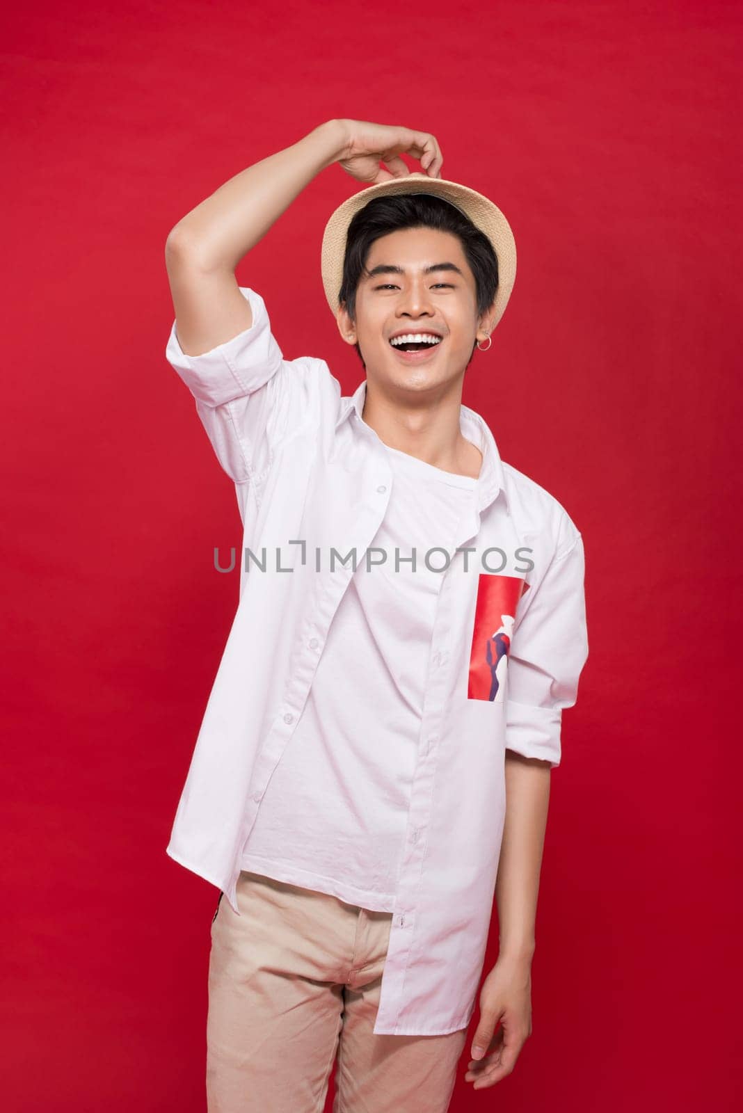 Portrait of elegant young handsome asian man with hat. Cool fashion male model.