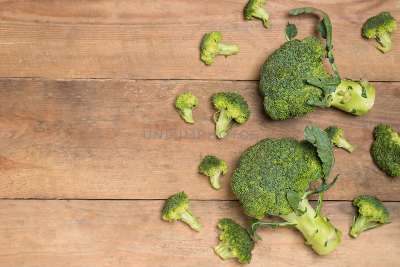 Top view of Fresh green broccoli on rustic wooden background - healthy or vegetarian food.