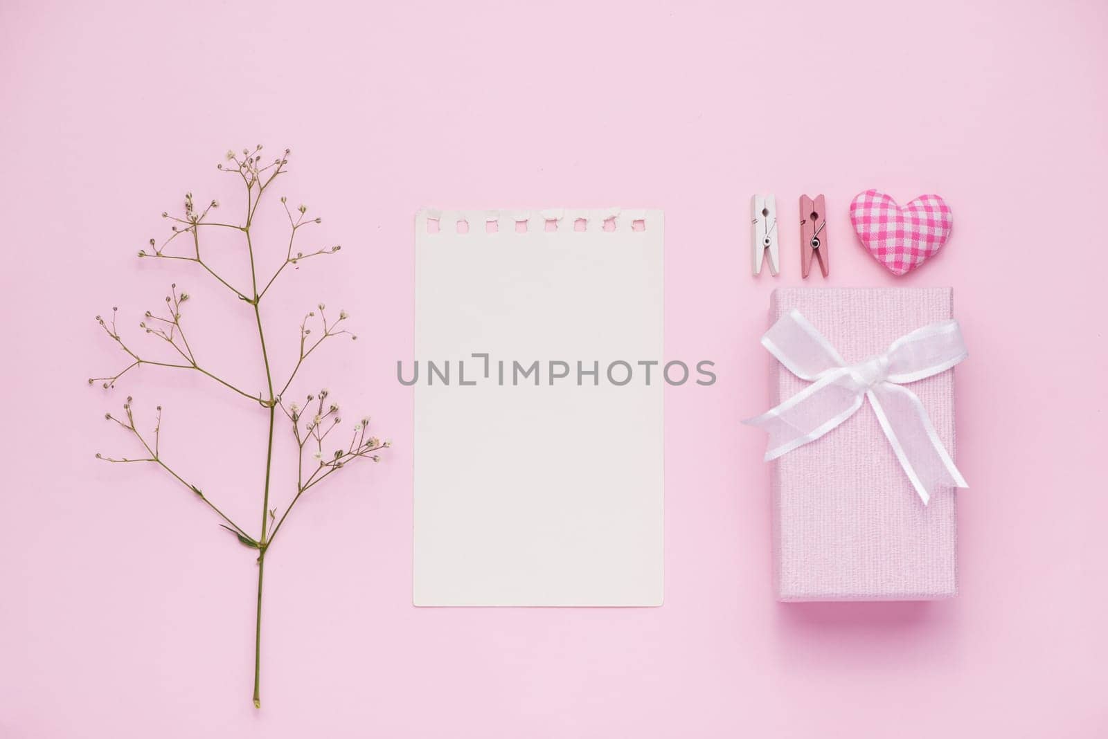 Gift box tied with pink ribbon and white flowers for mothers day