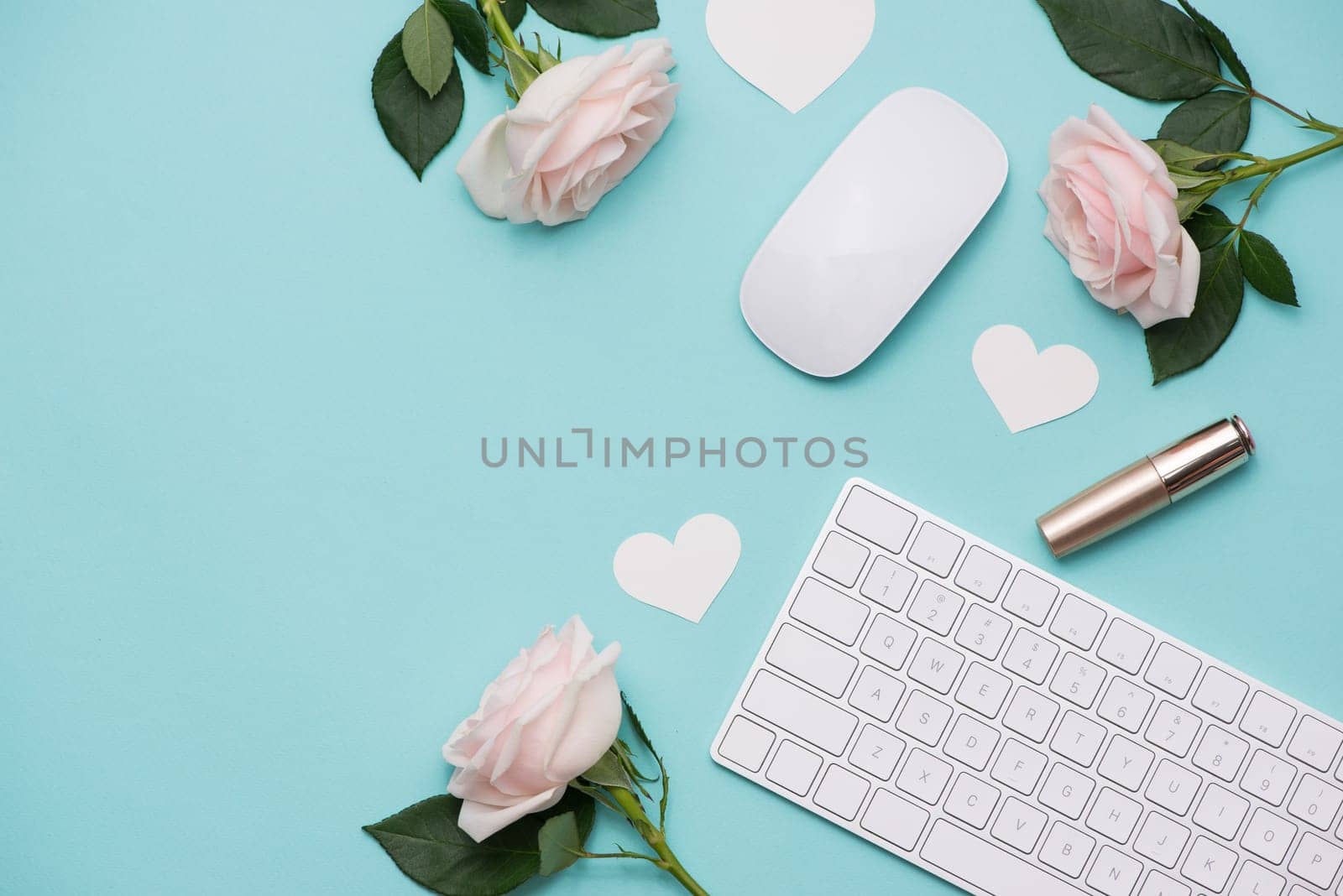Mother's Day concept. Pink roses with gift box on woman office desk. Open notebook for copy space.