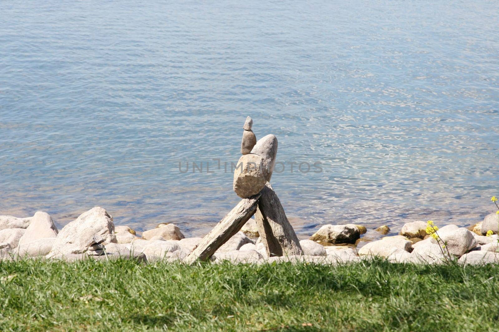 Stone stacks of natural stones,water surface in the background.