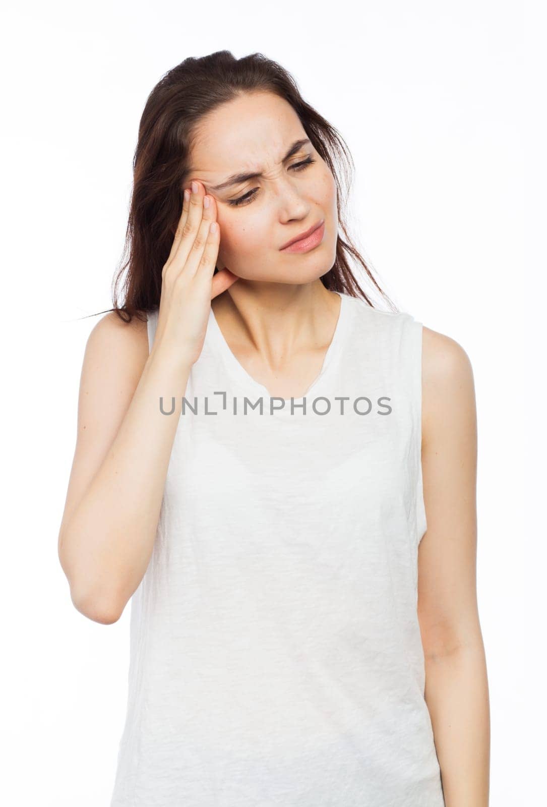 Young woman suffering of a headache, isolated on white