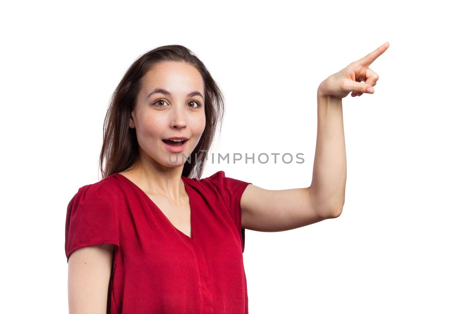 Casual brunette pointing at copy space, isolated on white