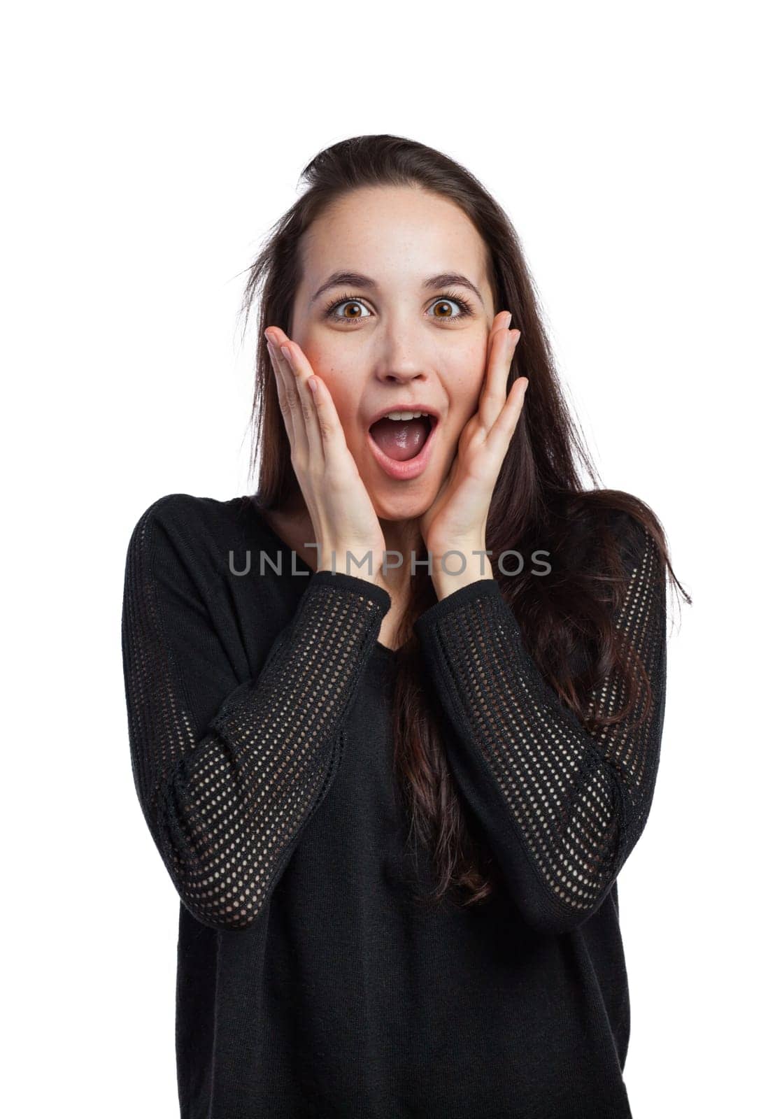 Young woman astonished and holding her face with her hands, isolated on white