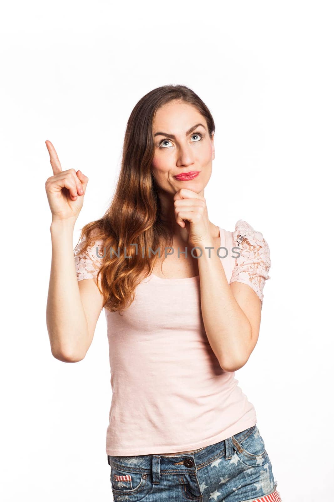 Portrait of a beautiful young woman pointing up, isolated on white