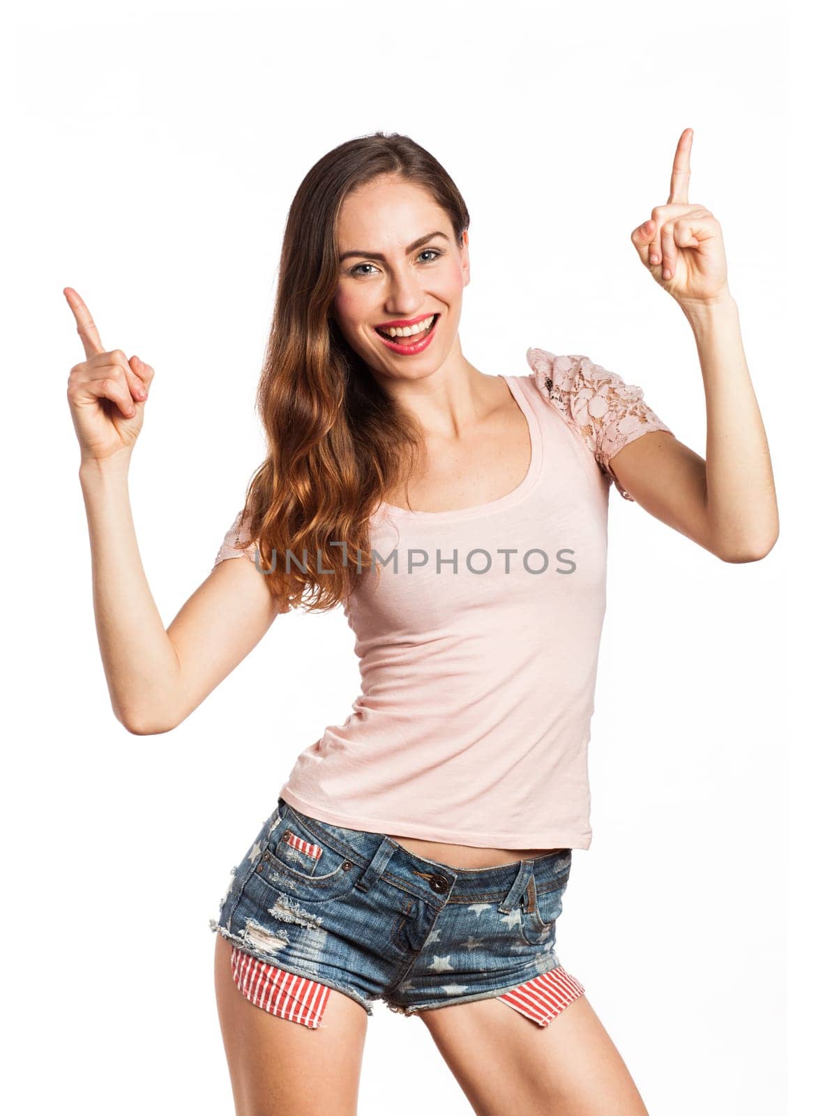 Portrait of a sexy woman pointing at the copy space, isolated on white