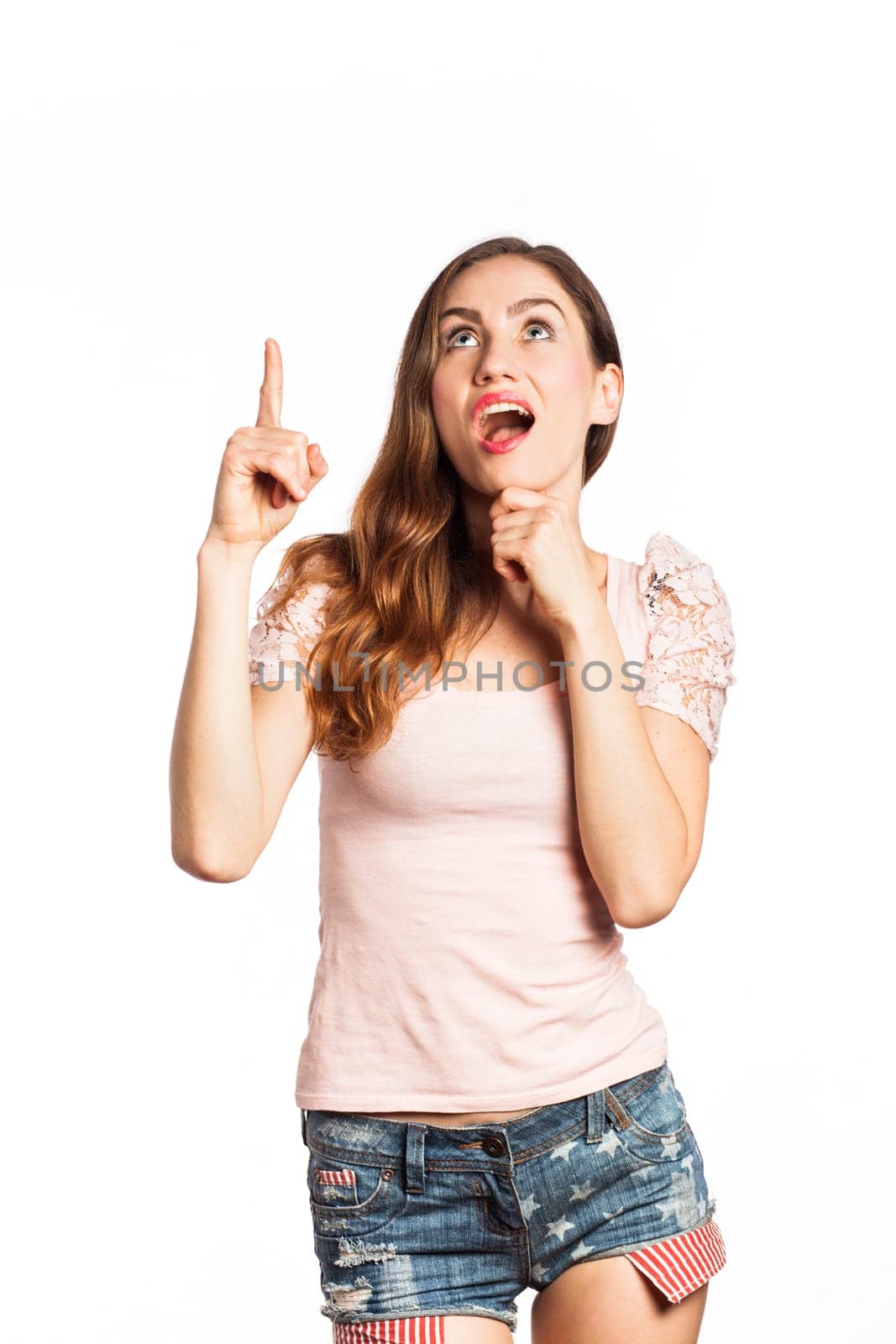 Portrait of a surprised woman pointing up, isolated on white