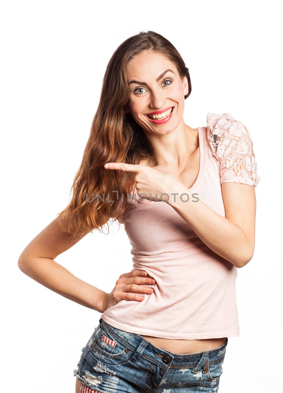 Portrait of a cheerful woman pointing at the copy space, isolated on white