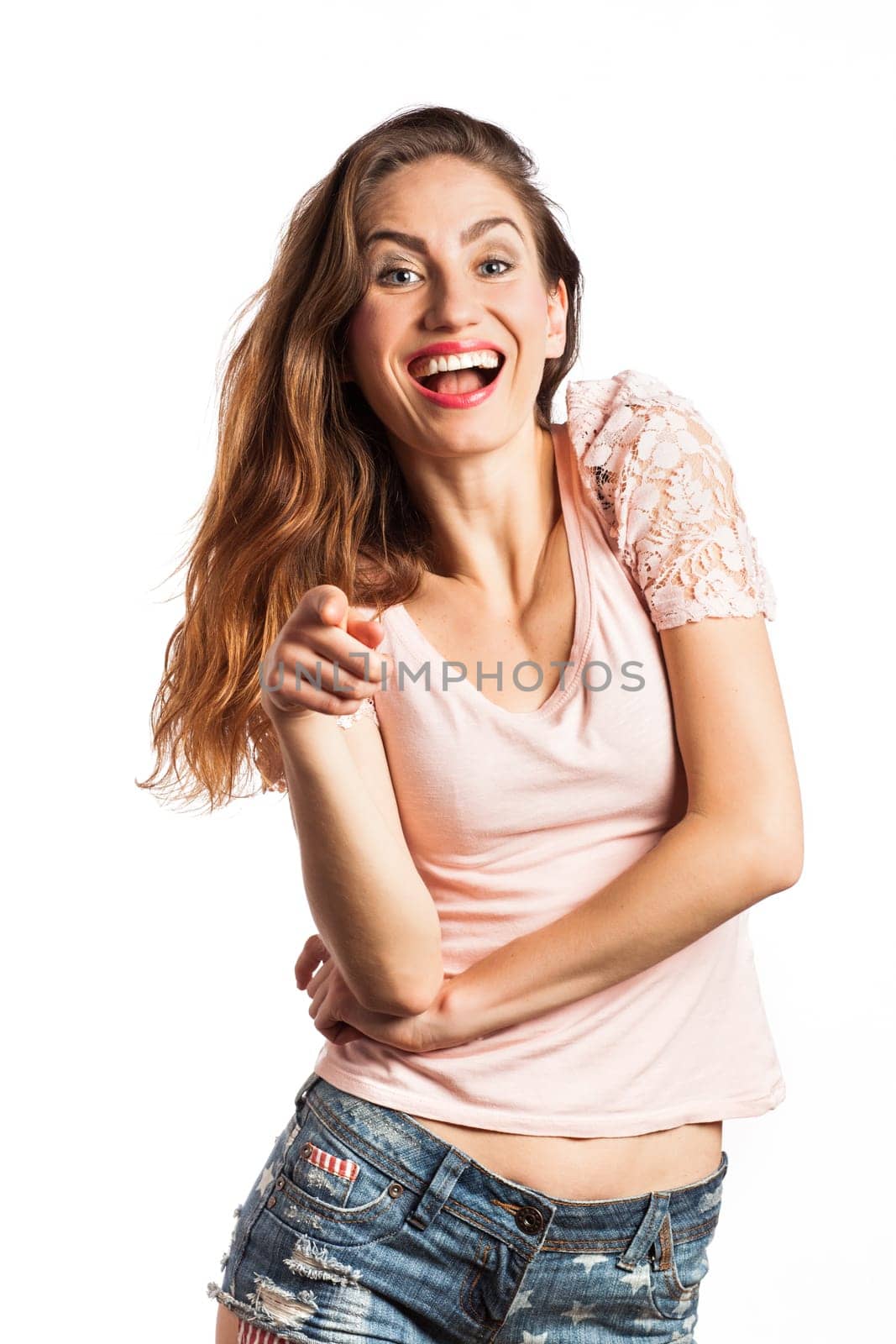 Portrait of a sexy woman pointing at the camera, isolated on white