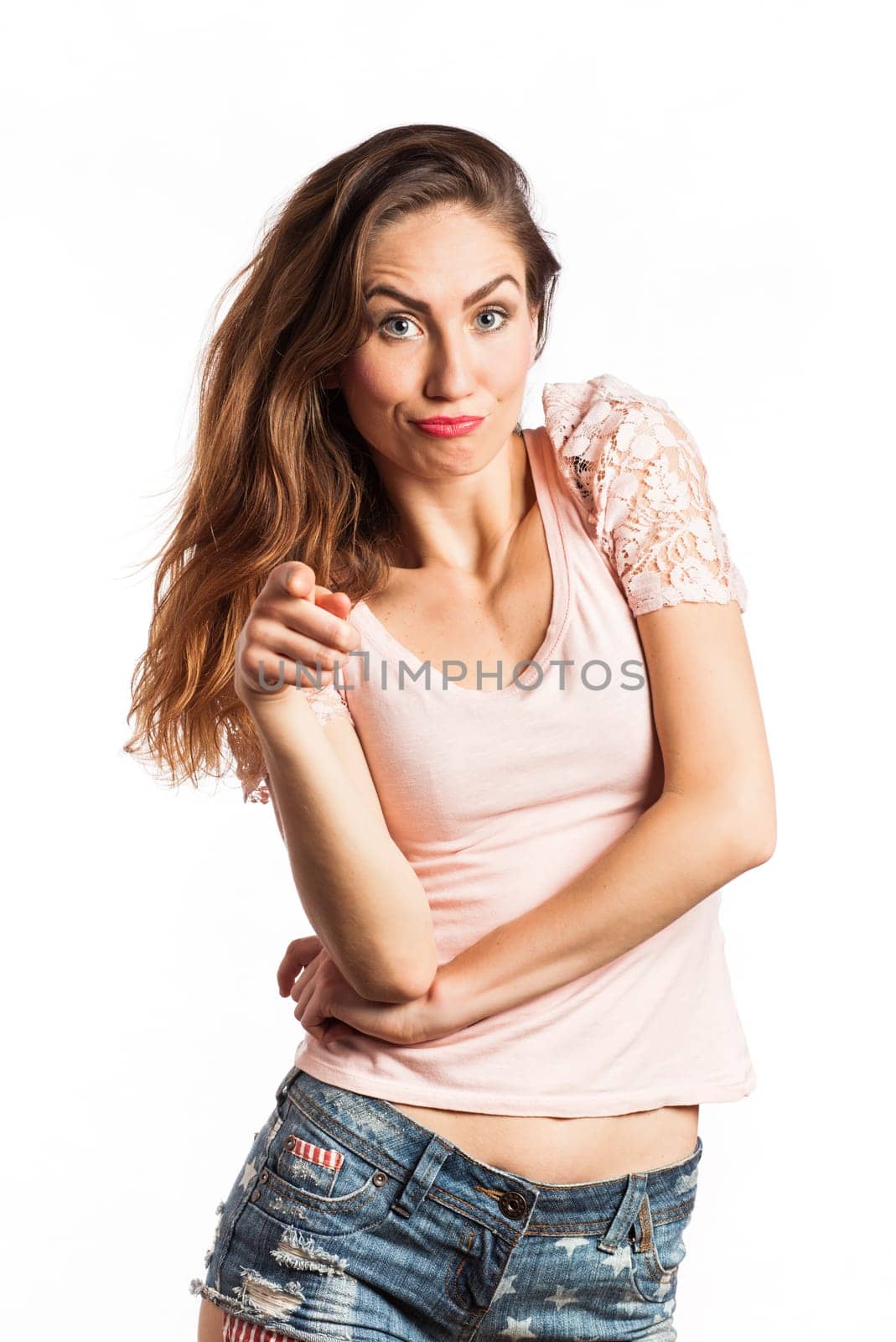 Portrait of a sexy woman pointing at the camera, isolated on white