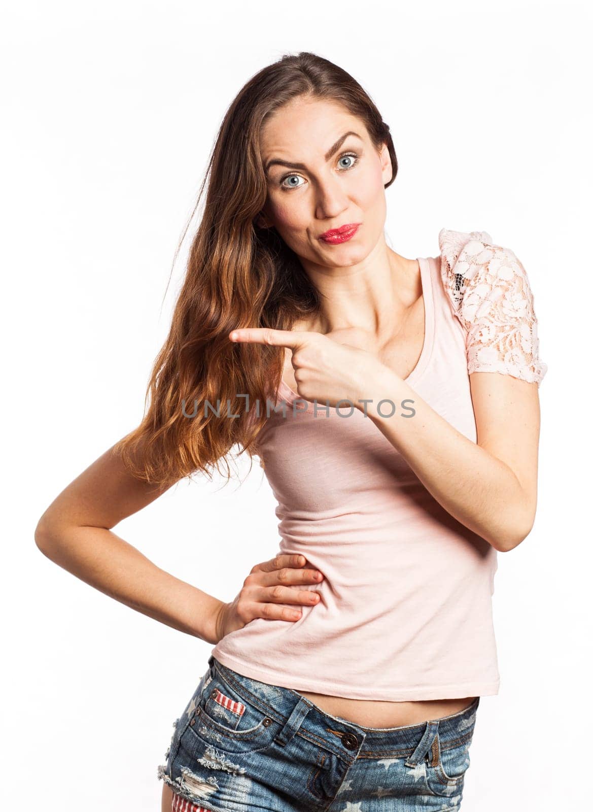 Portrait of a gorgeous woman pointing at the copy space, isolated on white