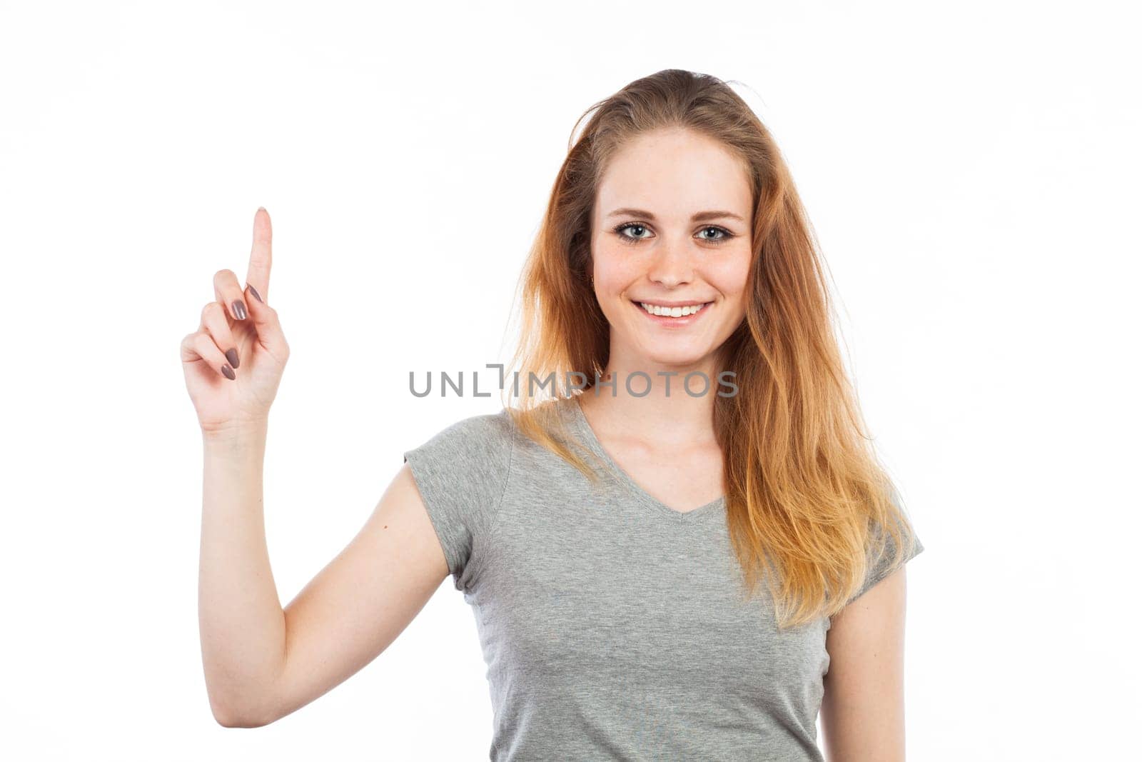 Portrait of an attractive woman pointing up, isolated on white