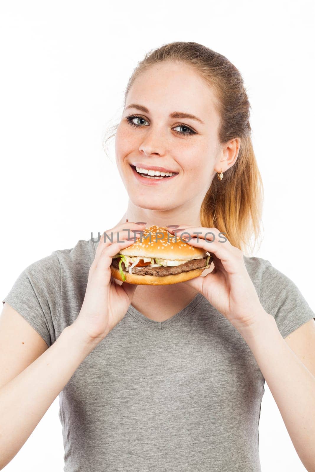 Portrait of a cute young woman holding a burger, isolated on white