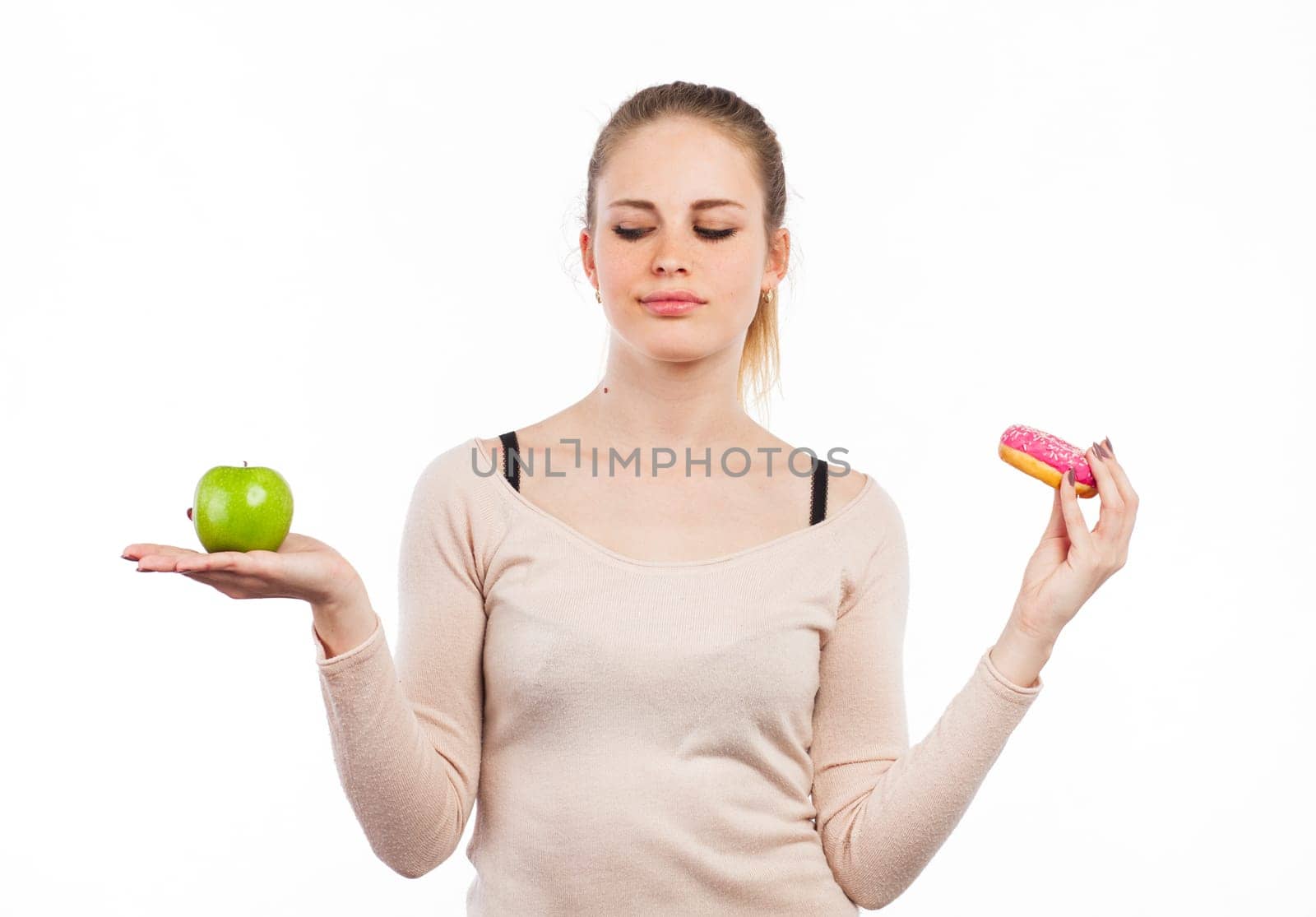 Portrait of a cute girl with a green apple and a donut, isolated on white