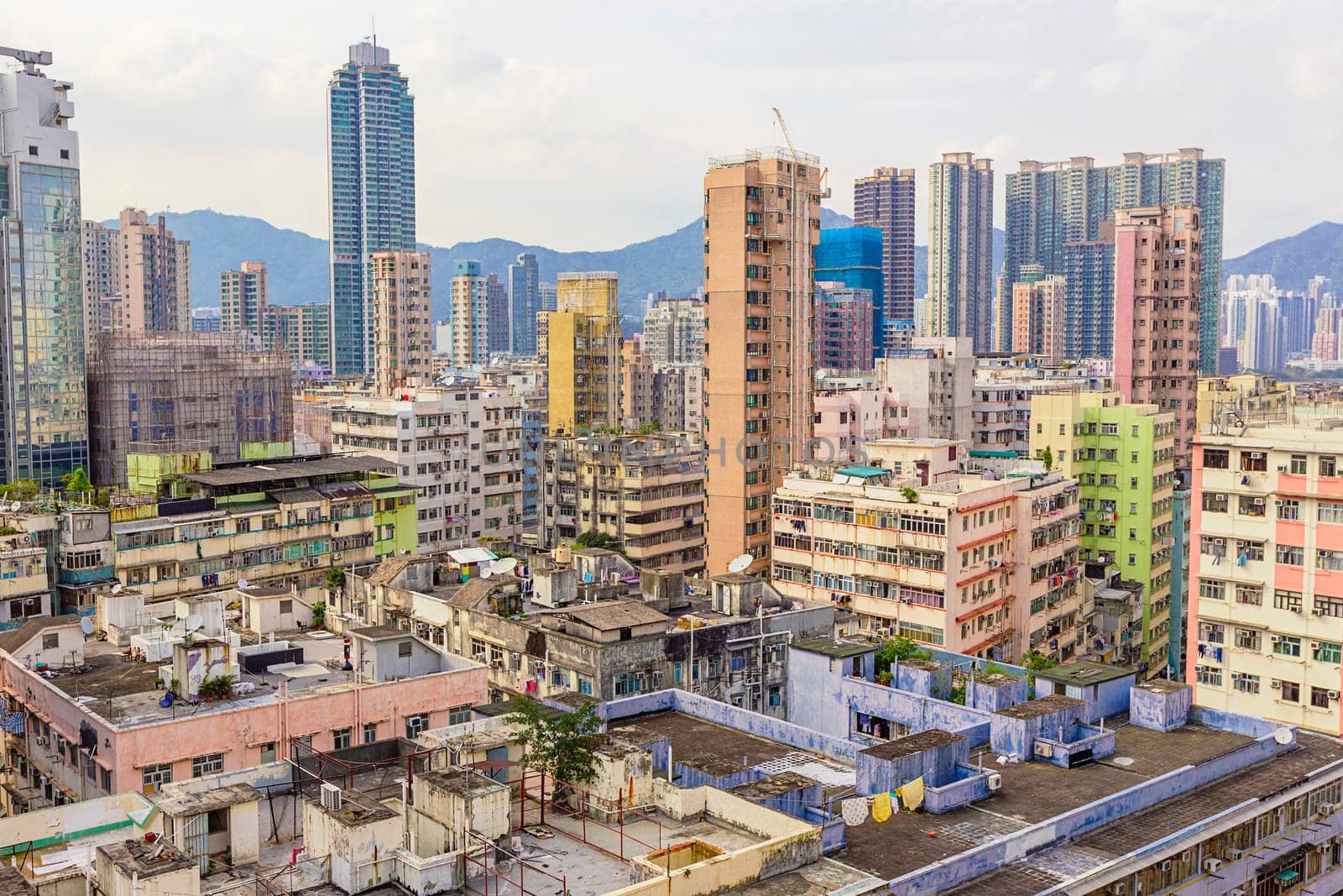 Old houses surrounded modern skyscrapers in Hong Kong. Hong Kong is popular tourist destination of Asia and leading financial centre of the world.
