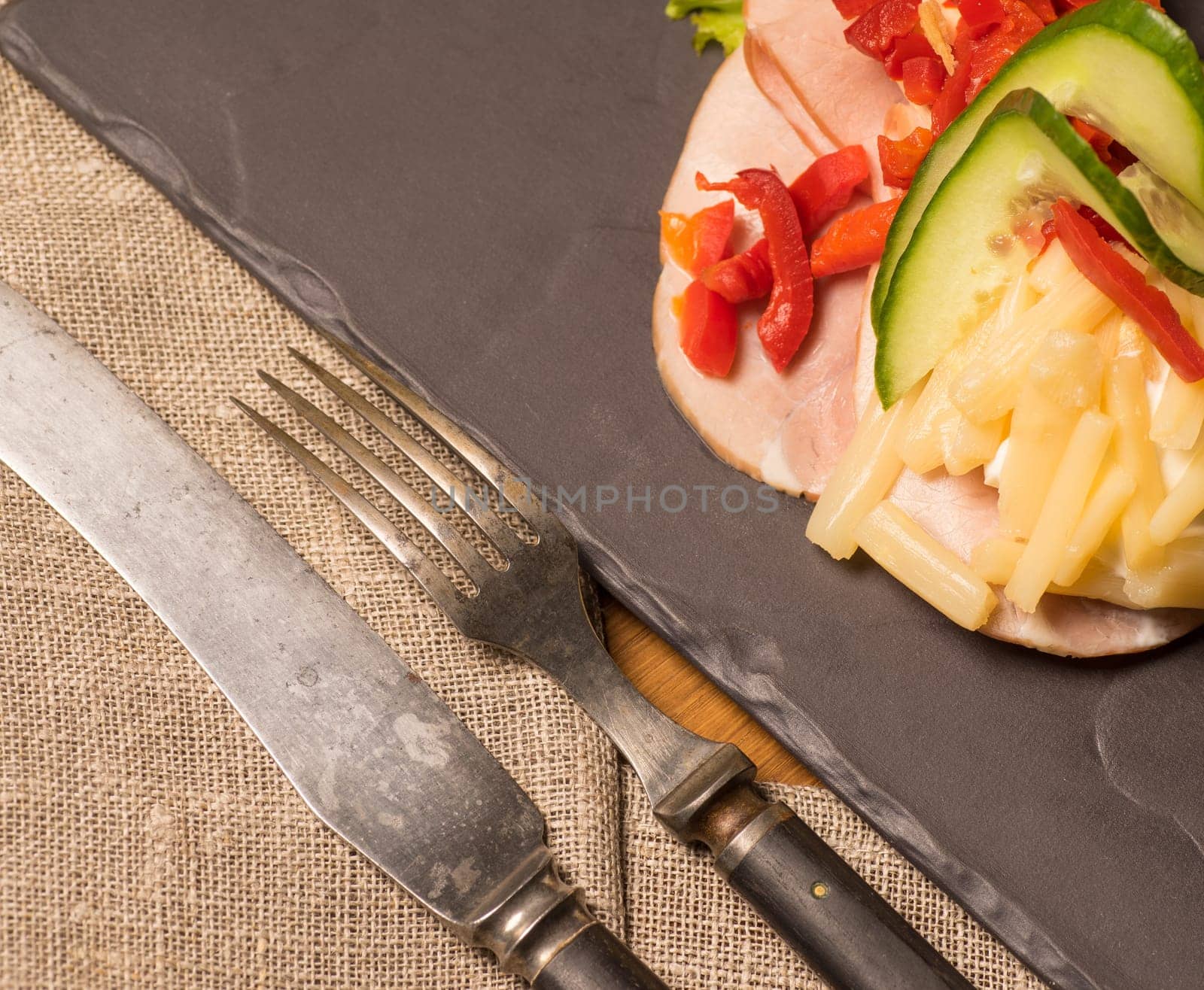 Danish specialties and national dishes, high-quality open sandwich. Sandwich with sliced ham, Mayonnaise Pickled peppers, asparagus and cucumbers served on a plate ready for eating