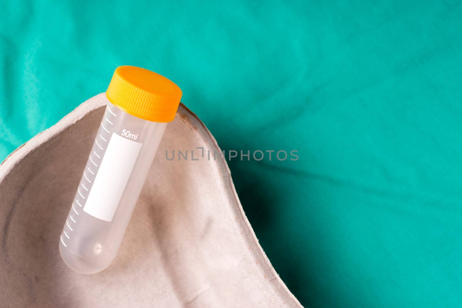 Medical Stethoscope lying on the hospital's green background. The background can be a textile part of a doctor or nurse's work uniform