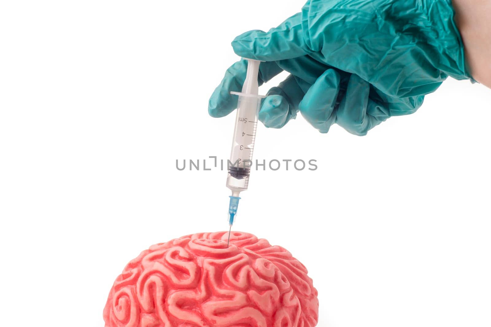 Brain injected with unknown drug. The injection is given by hand with green protective glove and is isolated on white background