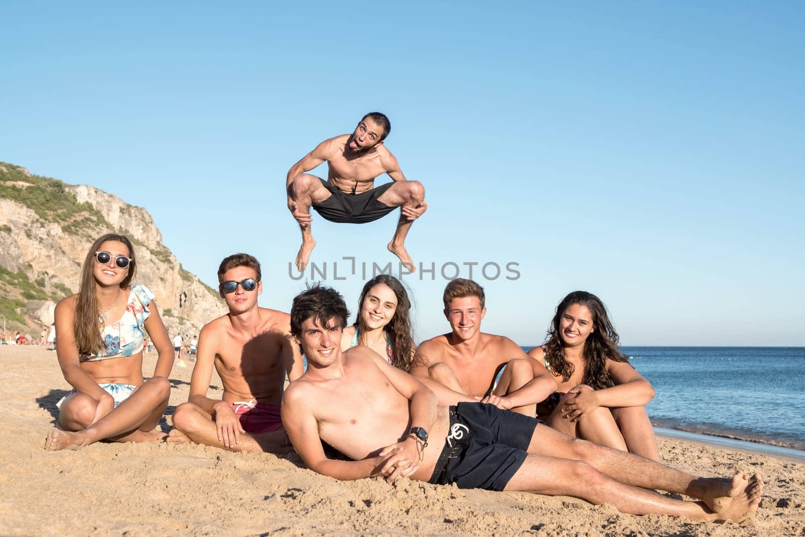 Group of happy teenage friends having fun at the beach