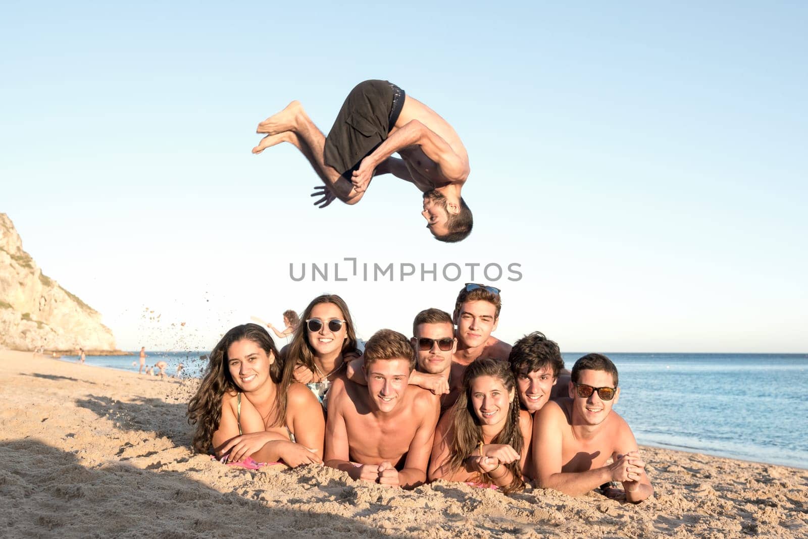 Group of happy teenage friends having fun at the beach