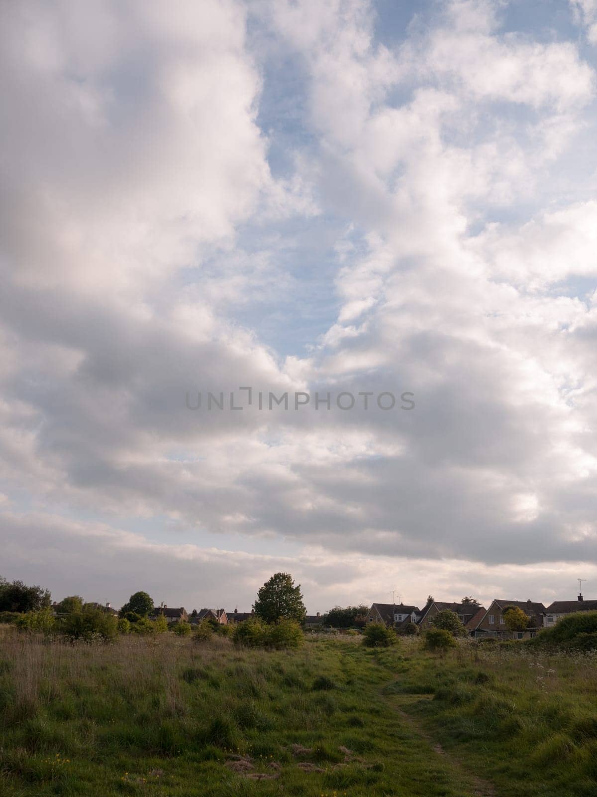 scene of countryside outside with clouds and path through the country to walk landscape peace in spring late afternoon