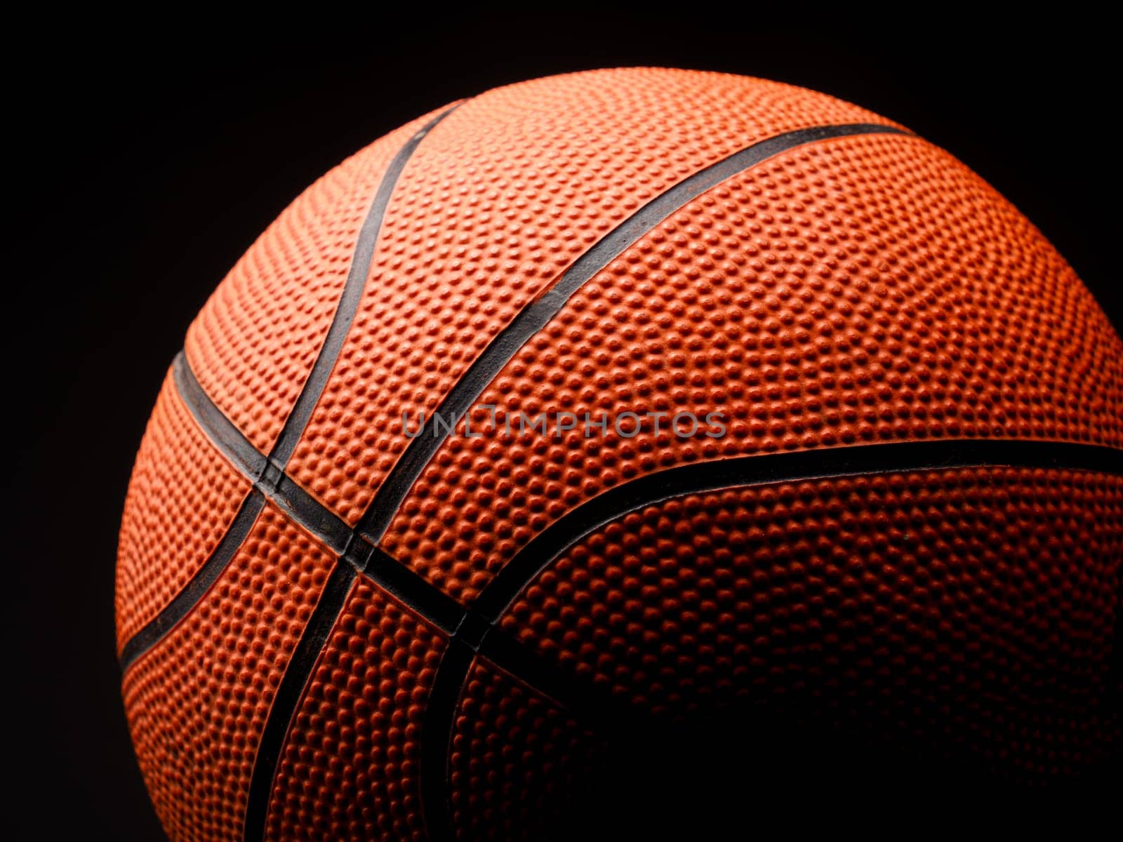 Close up shot of a basketball on a dark background
