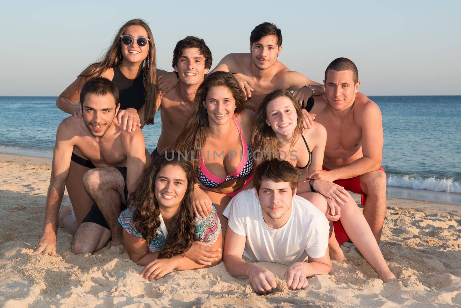 Group of happy teenage friends at the beach