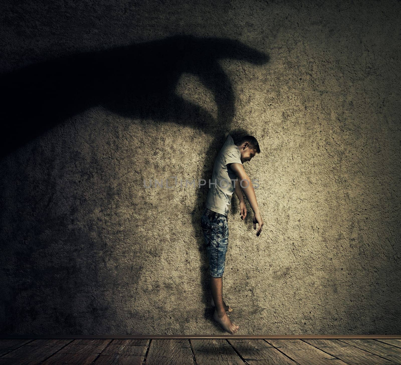 Human hand shadow holding a powerless man hanging. Conceptual image symbolizing manipulation, business control as a marionette.