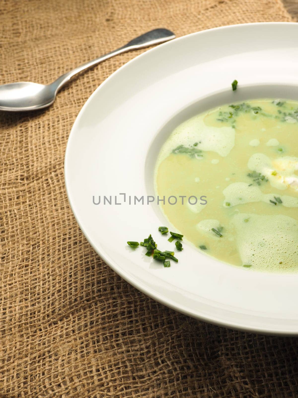 Tasty soup of peas on a rustic wooden table
