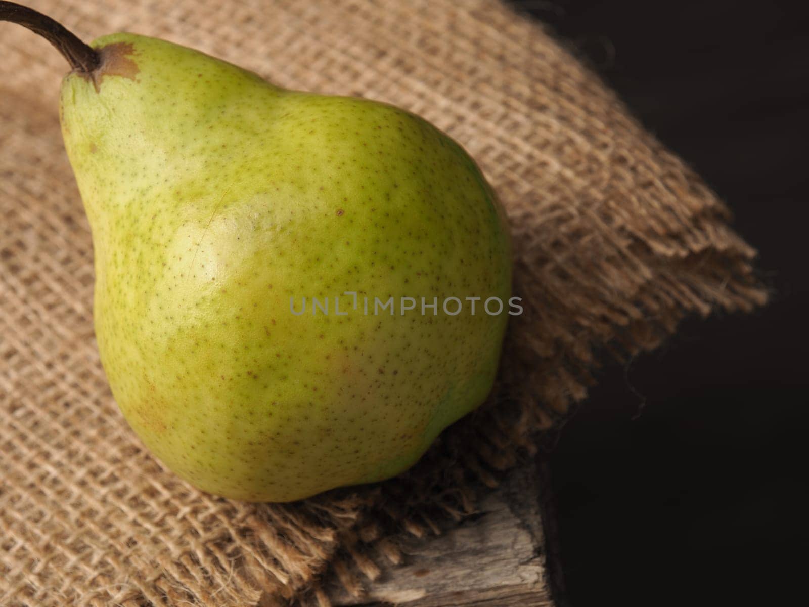 Fresh organic pear on an old wooden kitchen table