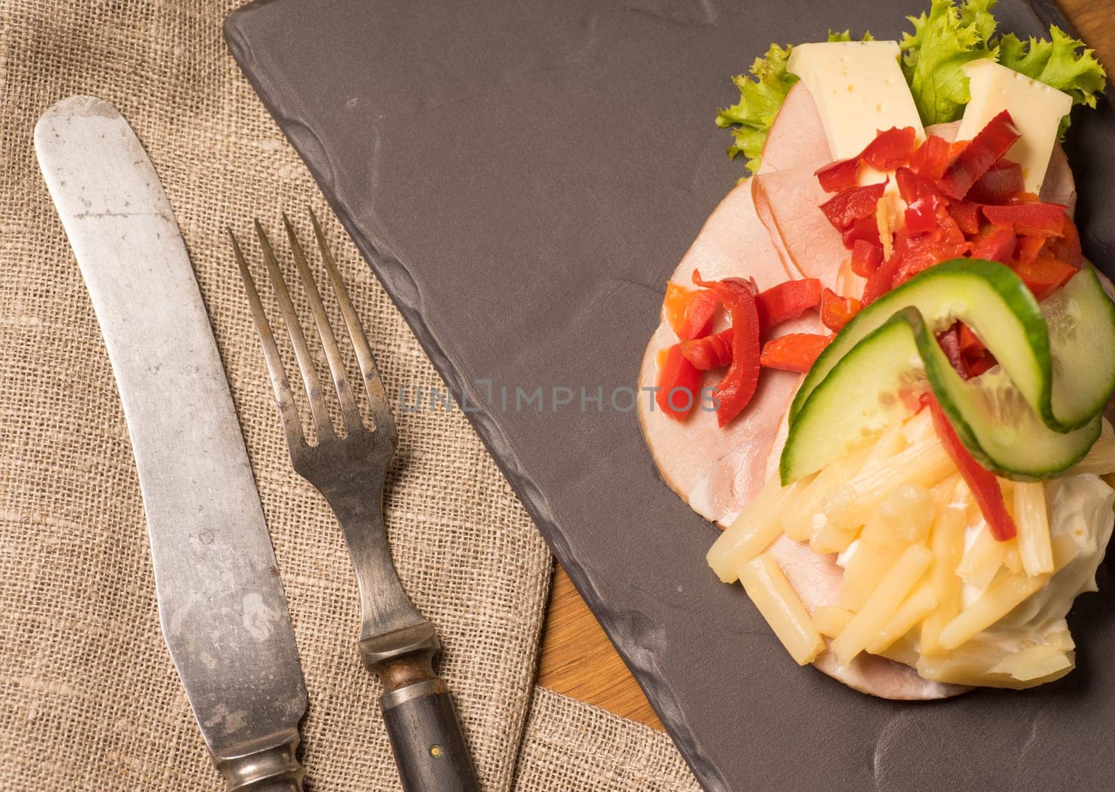 Danish specialties and national dishes, high-quality open sandwich. Sandwich with sliced ham, Mayonnaise Pickled peppers, asparagus and cucumbers served on a plate ready for eating
