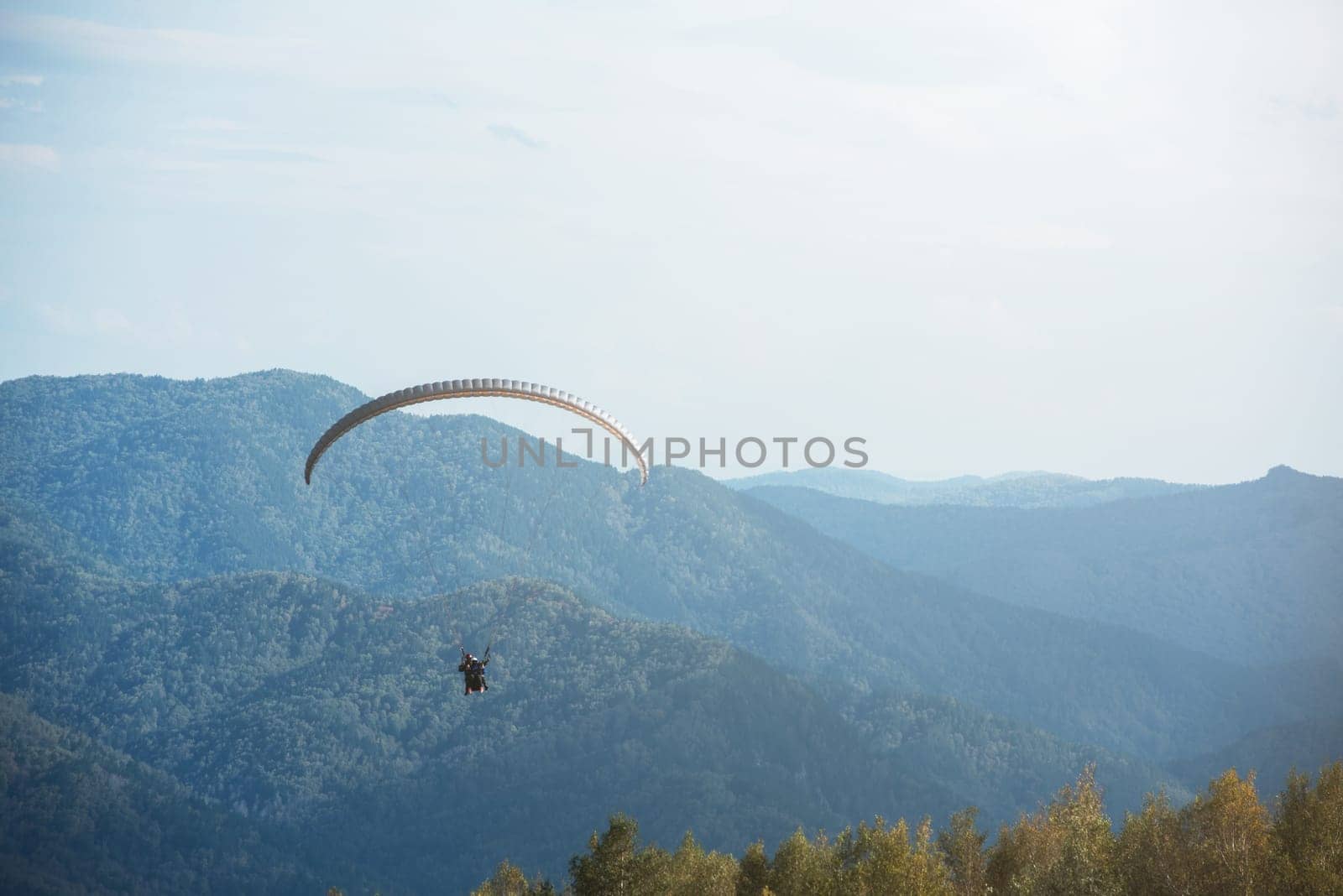Paragliding in mountains. Para gliders in fight in the mountains, extreme sport activity.