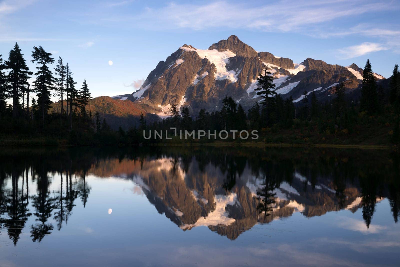 Light hits Mt Shuksan well at sunset above picture lake