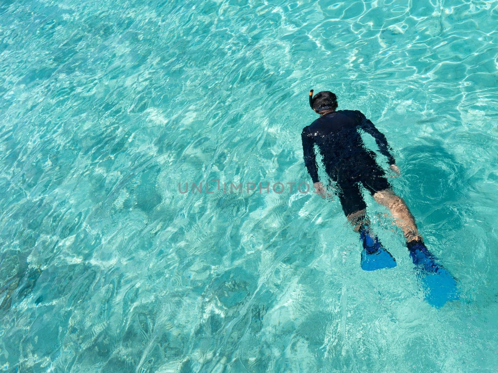 Young woman snorkeling in tropical water on vacation