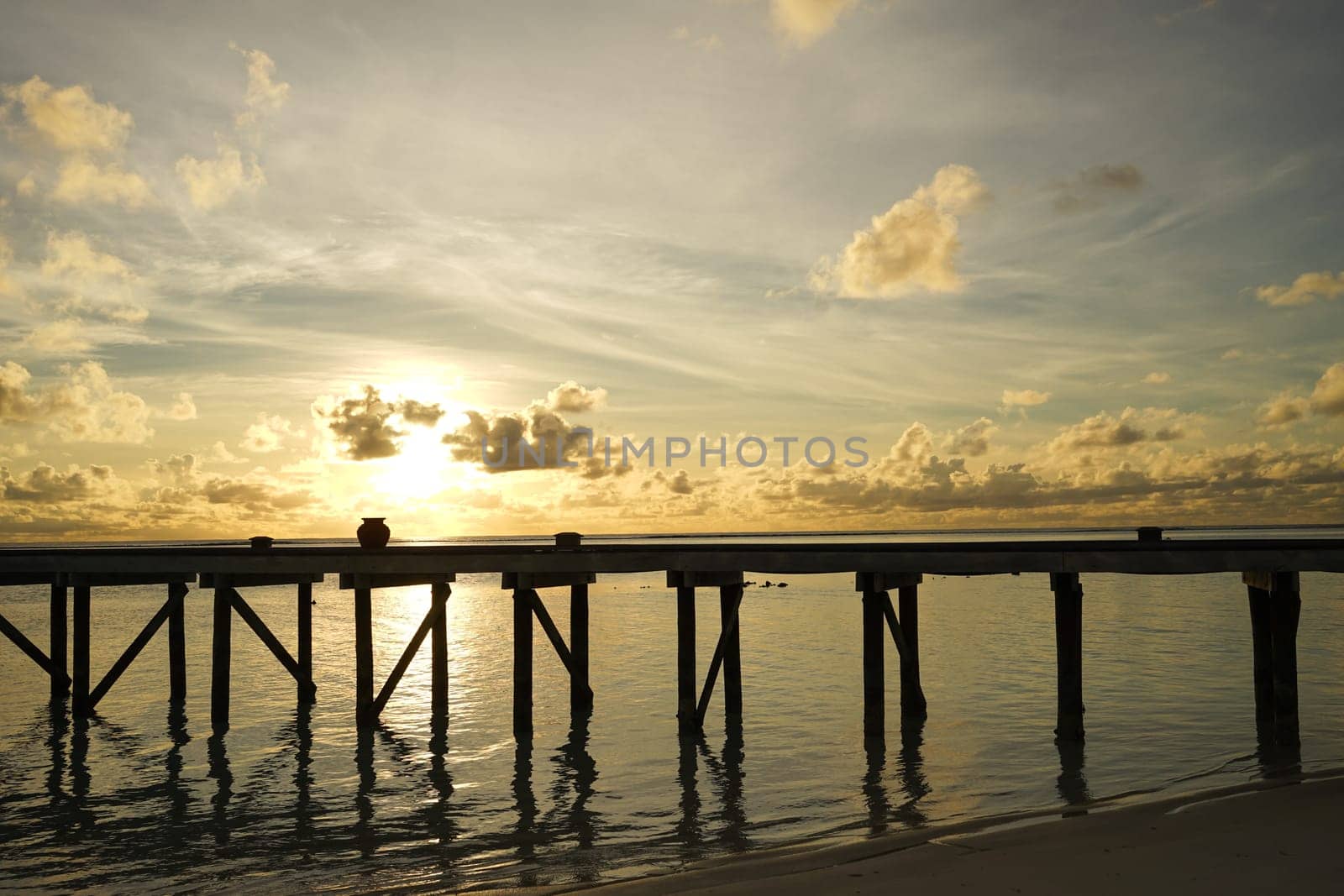 wooden bridge on the beach at dawn