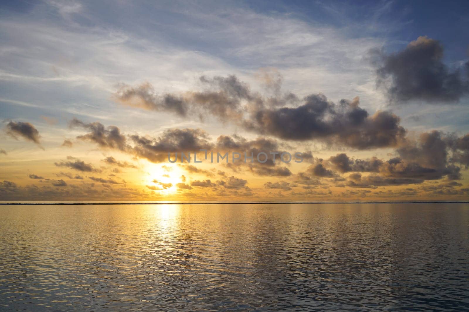 Colorful sunrise over tropical ocean on Maldives