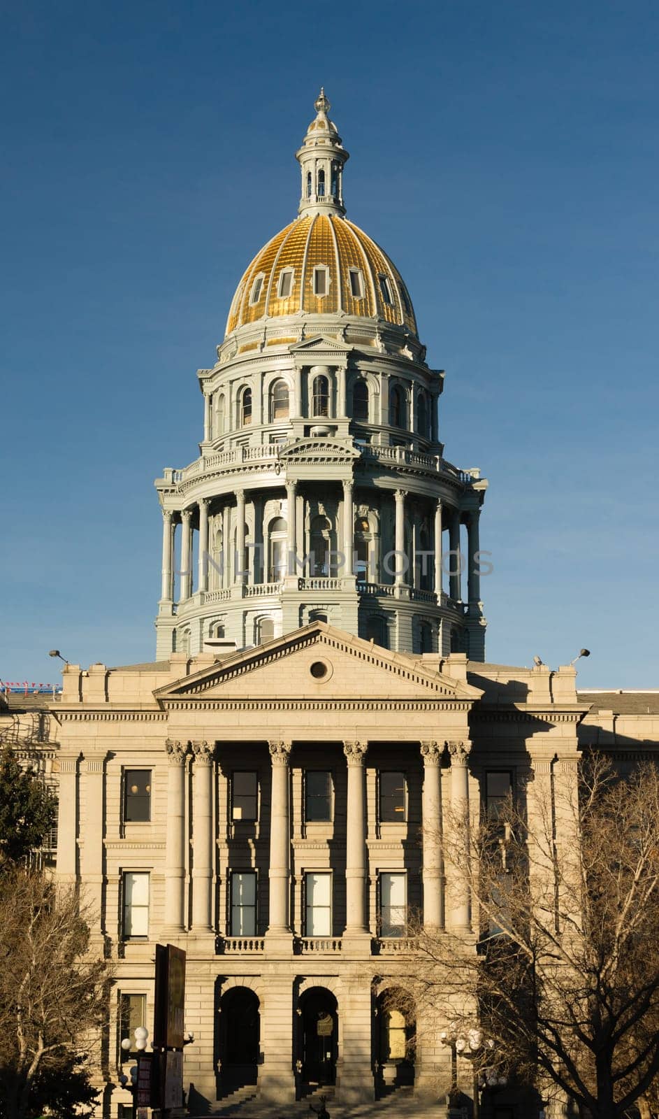 The US and State flags fly at Denver's Capital
