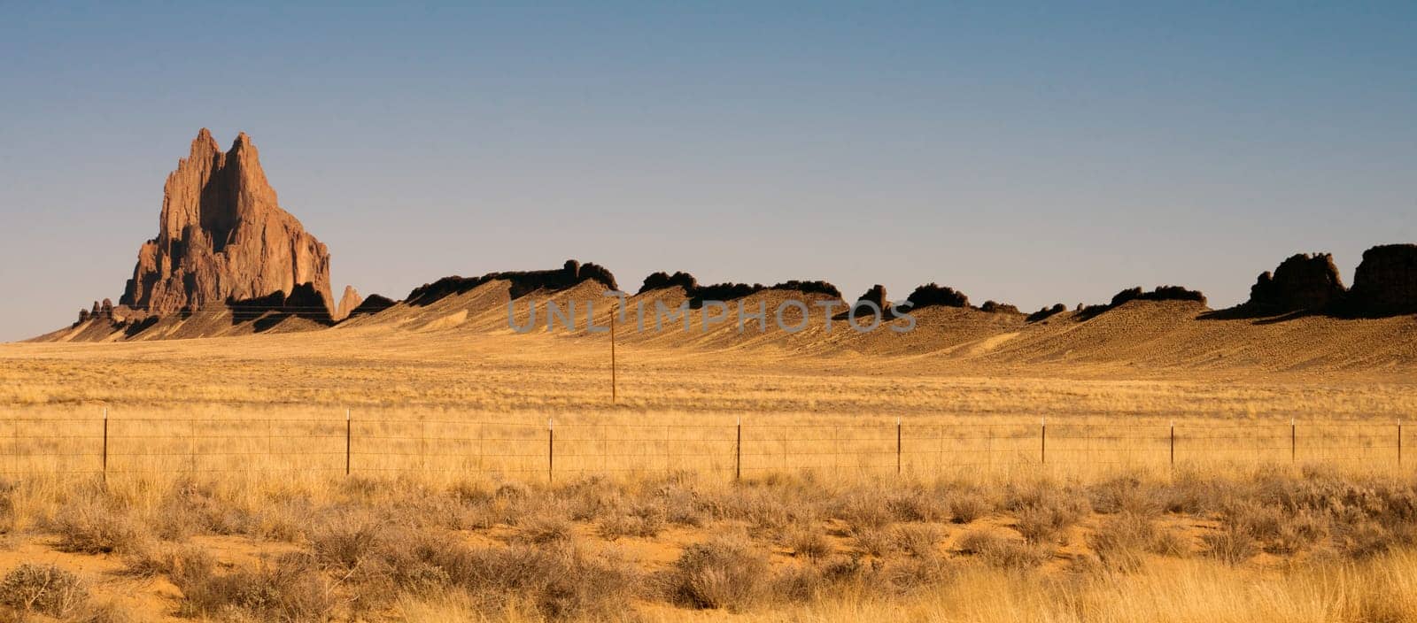 Blue skies appear in a panoramic view of Shiprock