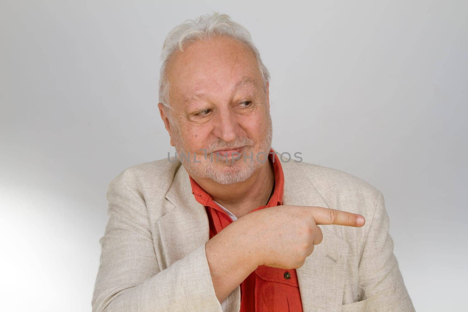 Senior points his finger on a light background