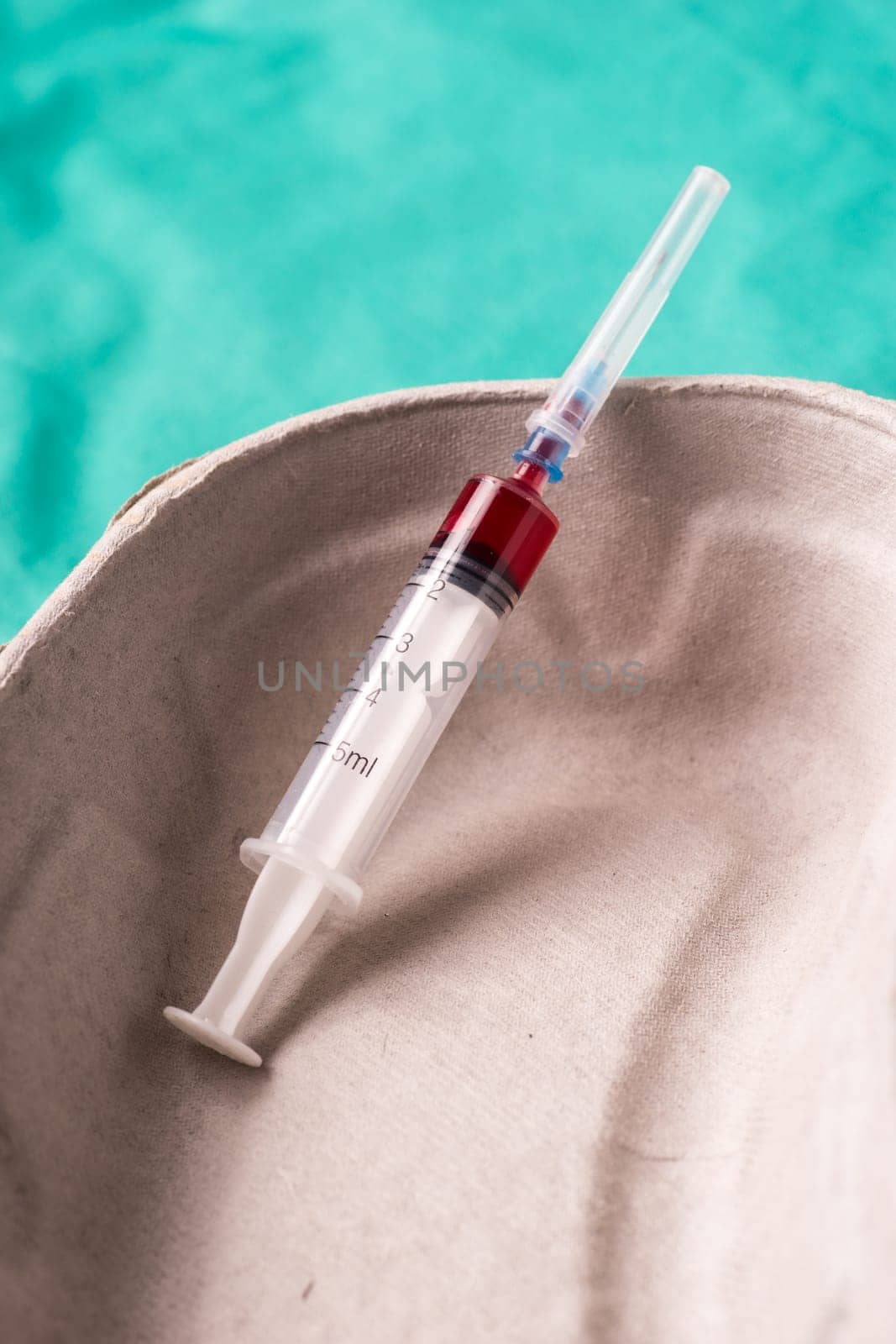 Medical Stethoscope lying on the hospital's green background. The background can be a textile part of a doctor or nurse's work uniform