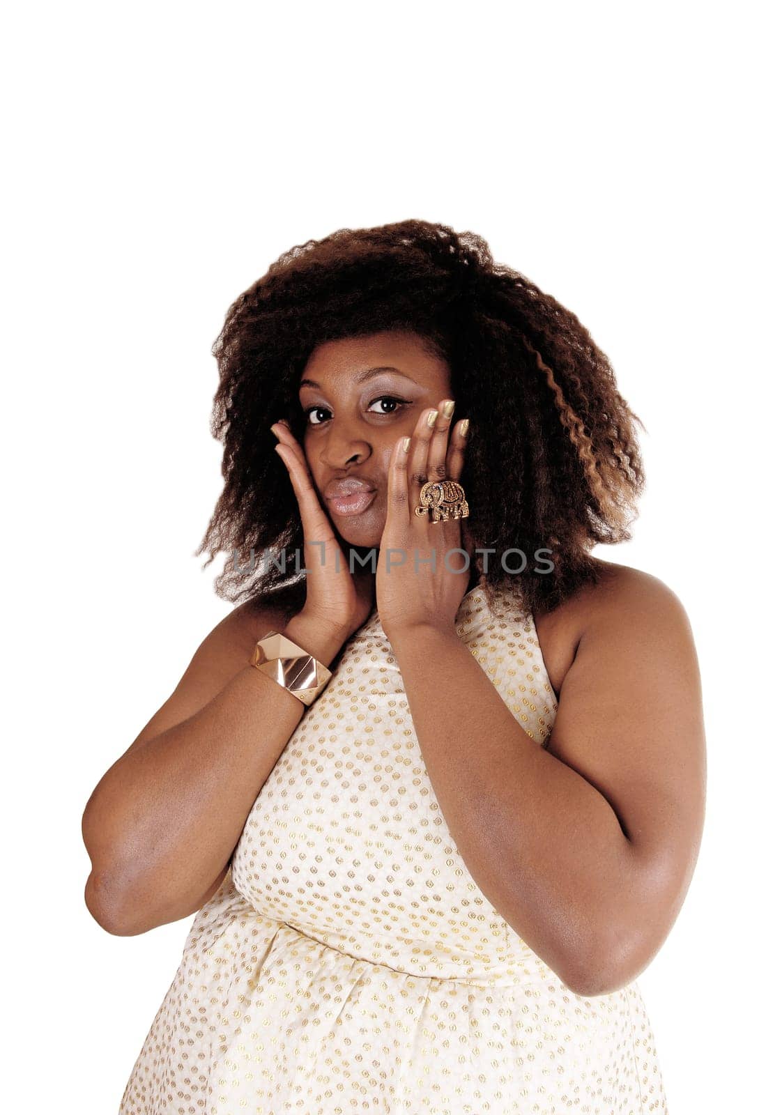 An closeuo image of a big African American woman in a beige dress with.her hands on her face, isolated for white background..