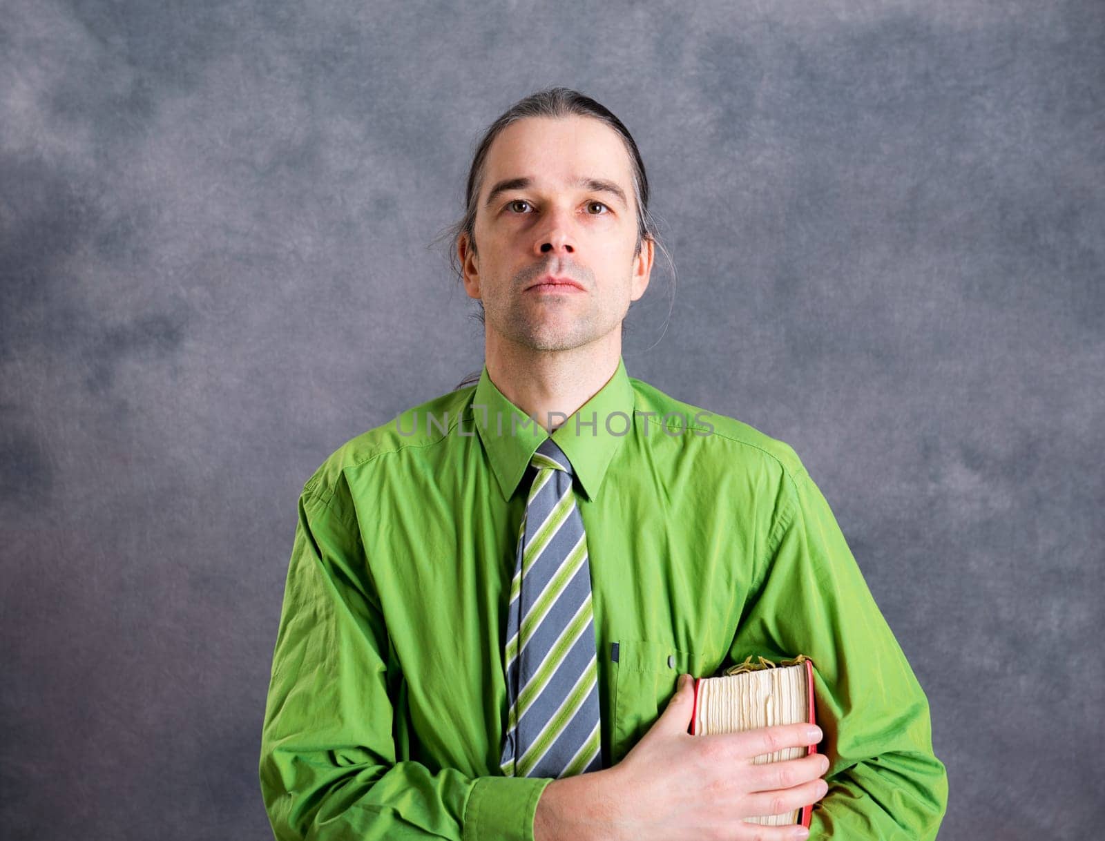 young lawyer in green shirt and necktie with statute book