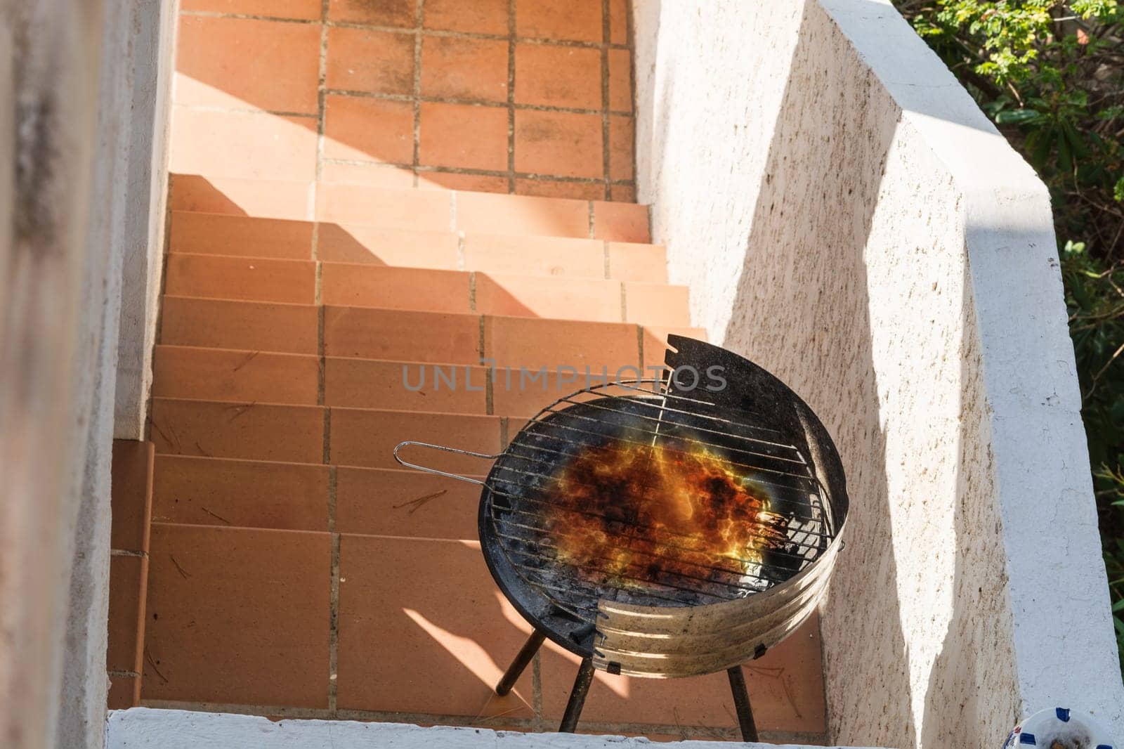 Used round simple BBQ grill filled with charcoal..